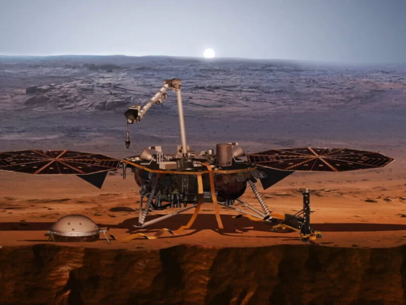 An artist’s concept of the InSight lander on Mars after the lander’s robotic arm deployed a seismometer (domed object to the left of the lander) and a heat probe directly onto the ground. The lander stopped recording data in 2022, but scientists are still mining the data for information about Mars’ interior.